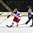 GRAND FORKS, NORTH DAKOTA - APRIL 21: Russia's Mikhail Bitsadz #9 skates with the puck while Finland's Joona Koppanen #15 chases him down during quarterfinal round action at the 2016 IIHF Ice Hockey U18 World Championship. (Photo by Minas Panagiotakis/HHOF-IIHF Images)


